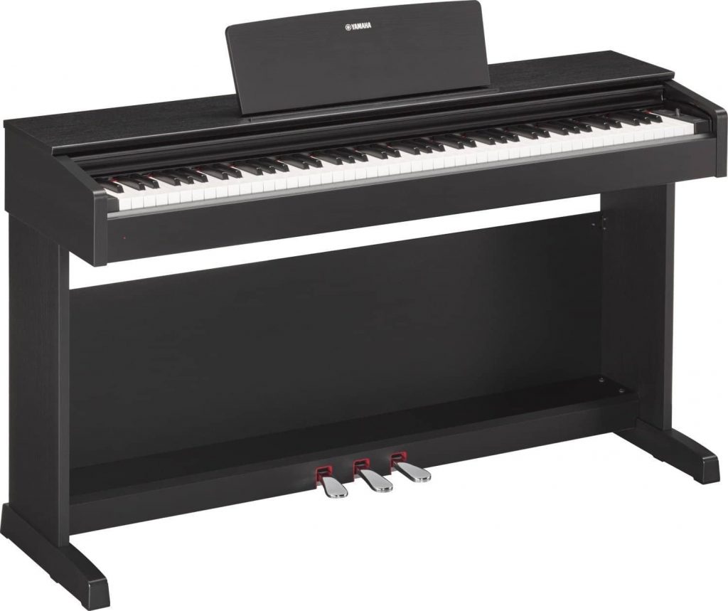 Yamaha console digital piano with a wood-grain finish and three built-in pedals